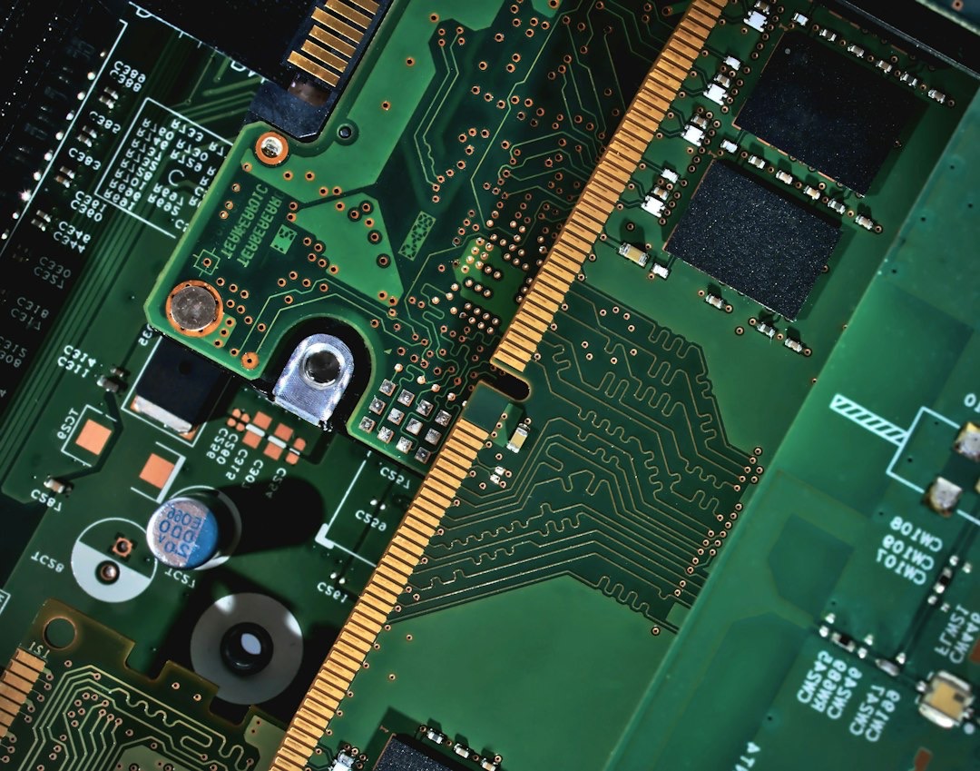Interconnected green circuit boards with golden contacts and microchips.